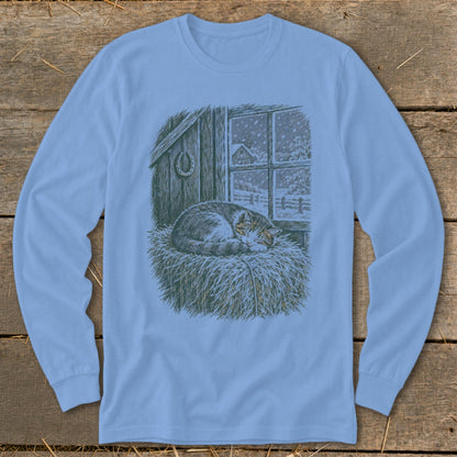 Long-sleeved shirt with a barn, horseshoe, and cat sleeping in hay scene.