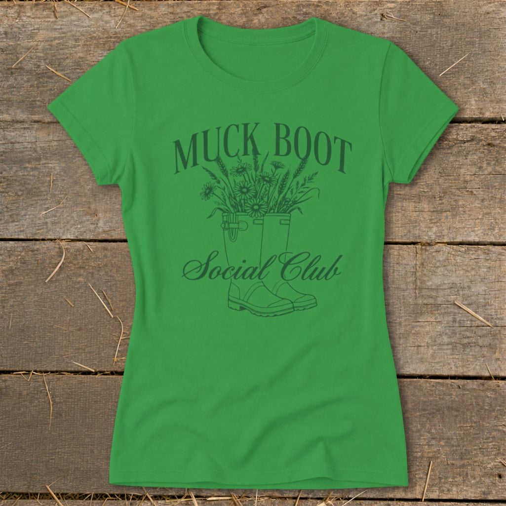 Green t-shirt with "Muck Boot Social Club" text and graphic of boots with flowers.