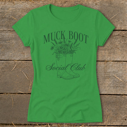 Green t-shirt with "Muck Boot Social Club" text and graphic of boots with flowers.