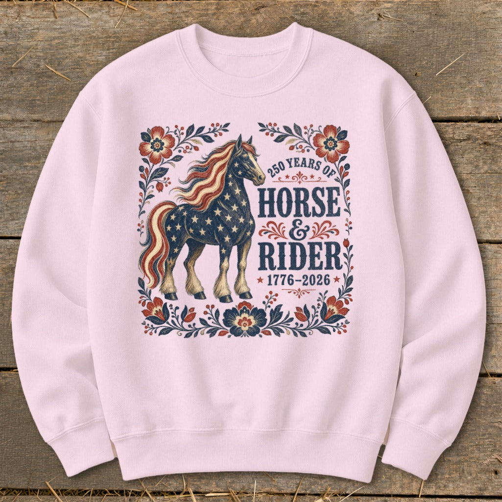 Pink sweatshirt with American flag horse design and text: "250 Years of Horse & Rider 1776-2026".
