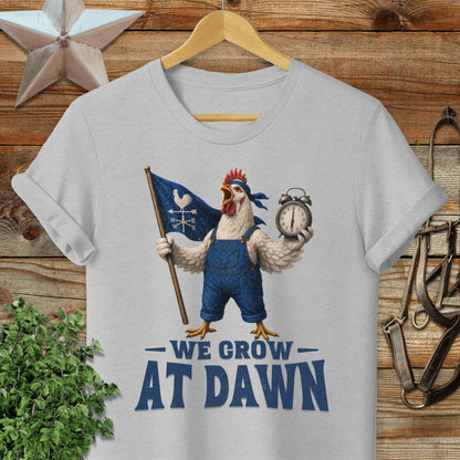 Chicken in overalls holds flag and alarm clock, "WE GROW DAWN" text.