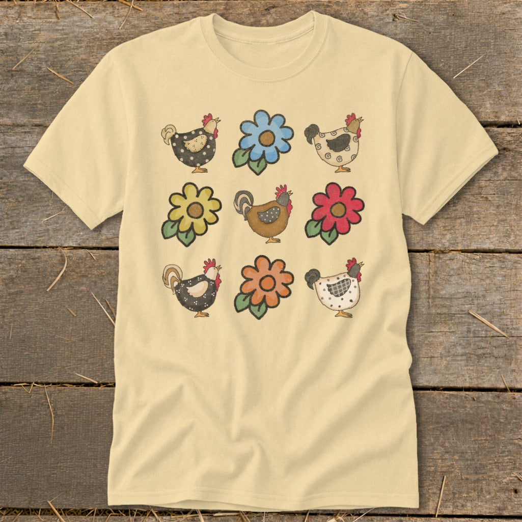 Light yellow t-shirt with a grid of nine farm-themed illustrations of chickens and flowers.