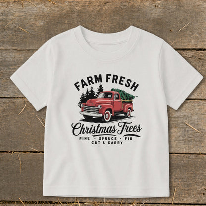 White t-shirt with vintage red truck and Christmas trees graphic.