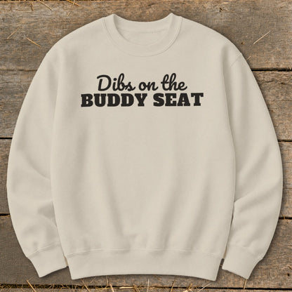Cream sweatshirt with black text "Dibs on the BUDDY SEAT."