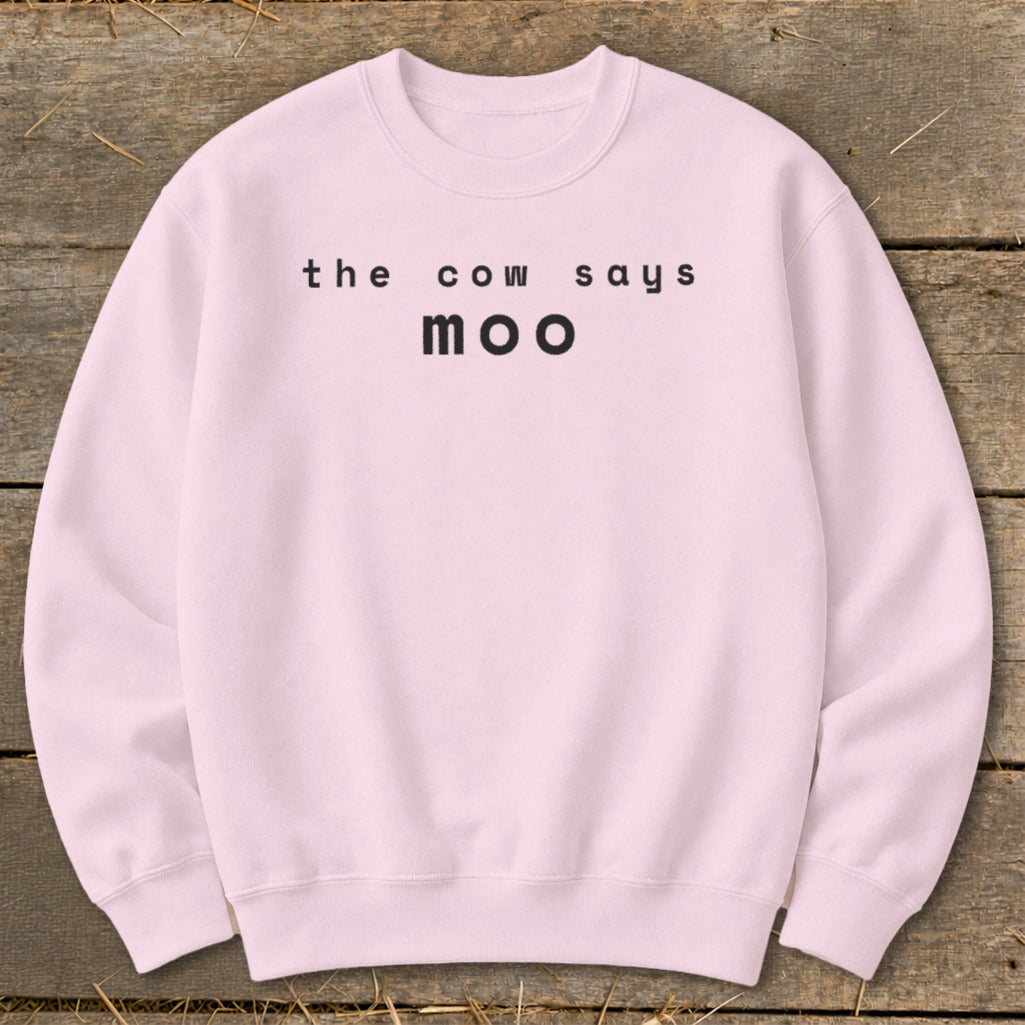 Pink sweatshirt with black text that says "the cow says moo".