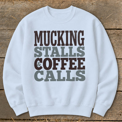 Light blue sweatshirt with "Mucking Stalls & Coffee Calls" text.