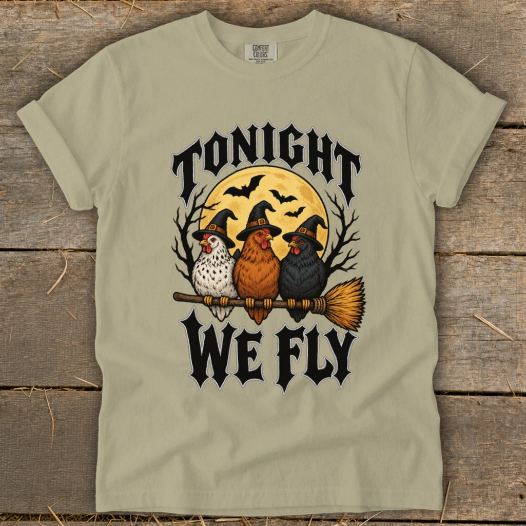 Three chickens in witch hats on a broomstick, "Tonight We Fly" text, moon and bats.