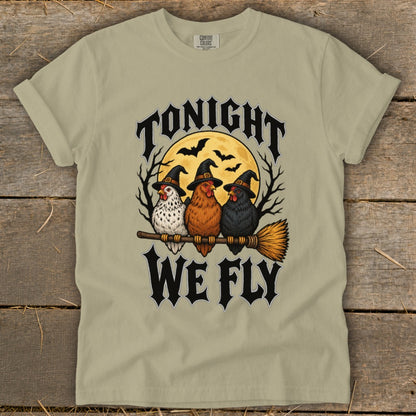 Three chickens in witch hats on a broomstick, "Tonight We Fly" text, moon and bats.