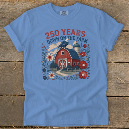 Blue t-shirt with red barn, eagle, flowers, and text "250 YEARS DOWN ON THE FARM".