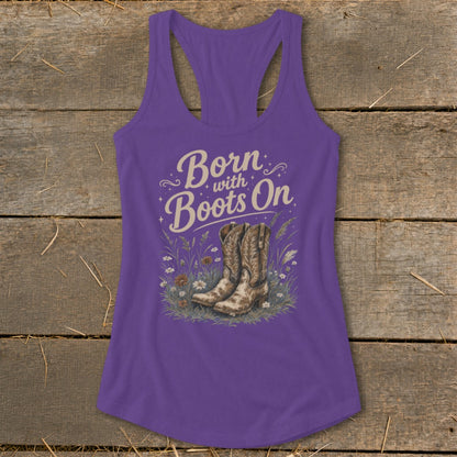 Purple tank top with "Born with Boots On" text and cowboy boots in grass graphic.