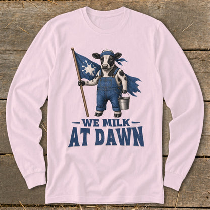 Cow in overalls and cape holding flag and bucket, text "WE MILK AT DAWN".