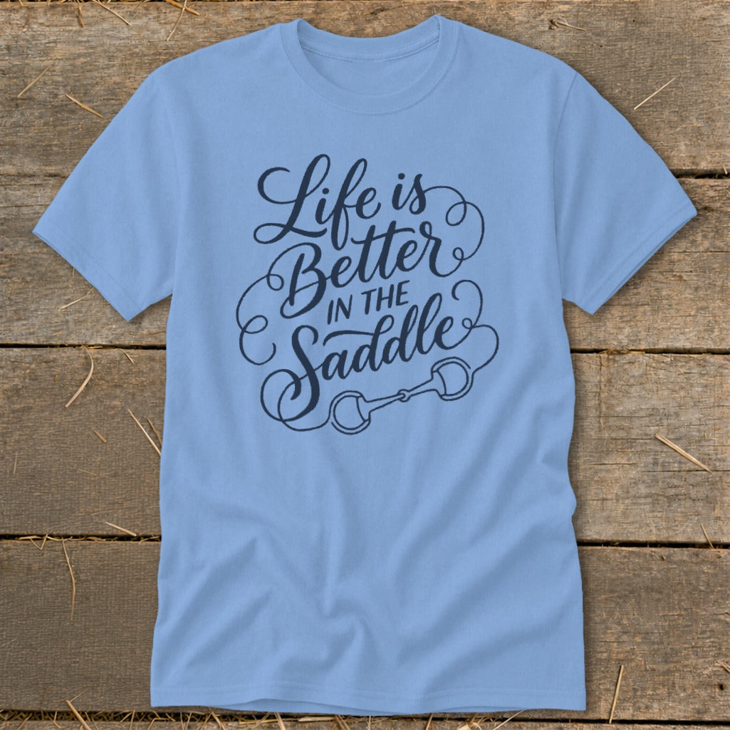 Light blue t-shirt with "Life is Better in the Saddle" text and horse bit graphic.