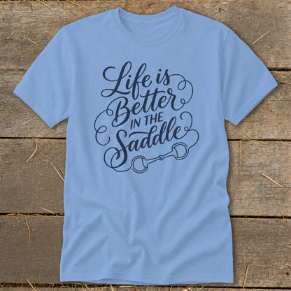 Light blue t-shirt with "Life is Better in the Saddle" text and horse bit graphic.
