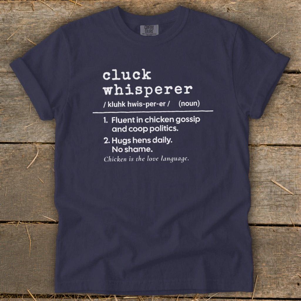 Navy t-shirt with white text defining "cluck whisperer."