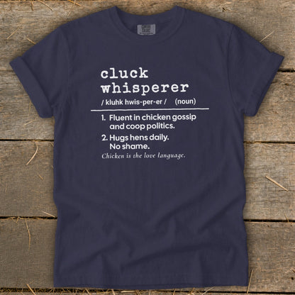 Navy t-shirt with white text defining "cluck whisperer."