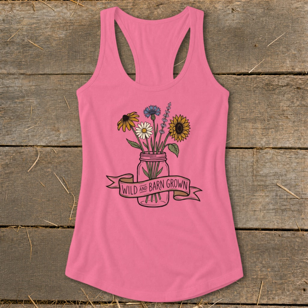 Pink tank top with a mason jar bouquet and "Wild and Barn Grown" banner.
