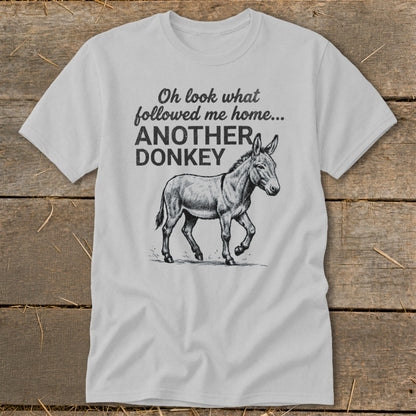 Light grey t-shirt with text "Oh look what followed me home... ANOTHER DONKEY" and a donkey illustration.