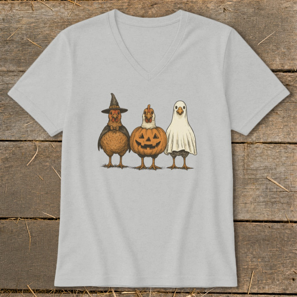 Three chickens dressed as a witch, pumpkin, and ghost.