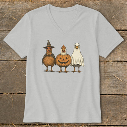 Three chickens dressed as a witch, pumpkin, and ghost.