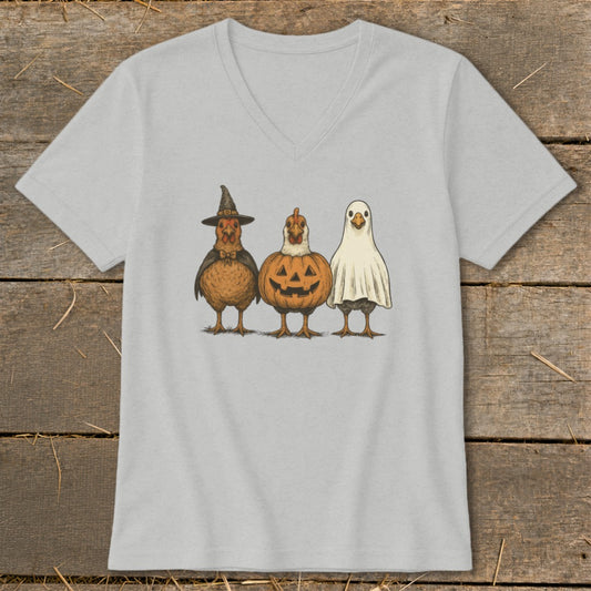 Three chickens dressed as a witch, pumpkin, and ghost.