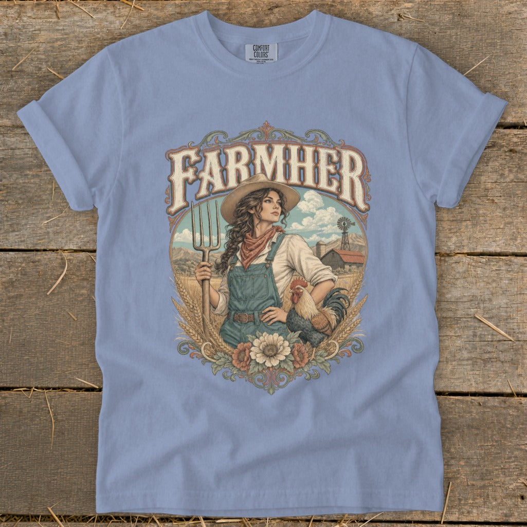 "Farmer" graphic on a light blue t-shirt with a woman, rooster, and farm scene.