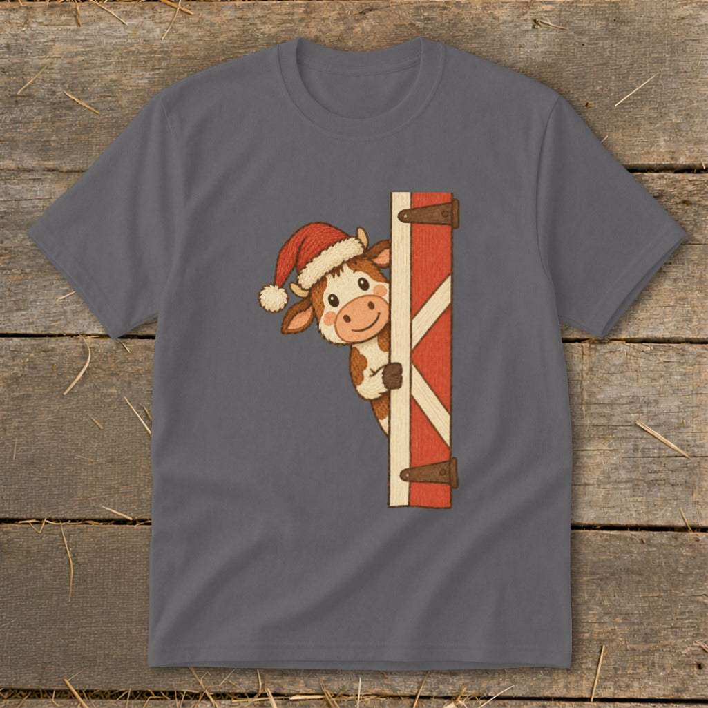 Cute cow wearing Santa hat peeks from behind a red wooden door.