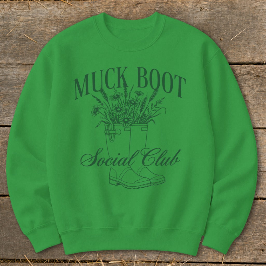 Green sweatshirt with "MUCK BOOT Social Club" text and floral boot design.