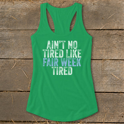 Green tank top with "Ain't No Tired Like Fair Week Tired" text.