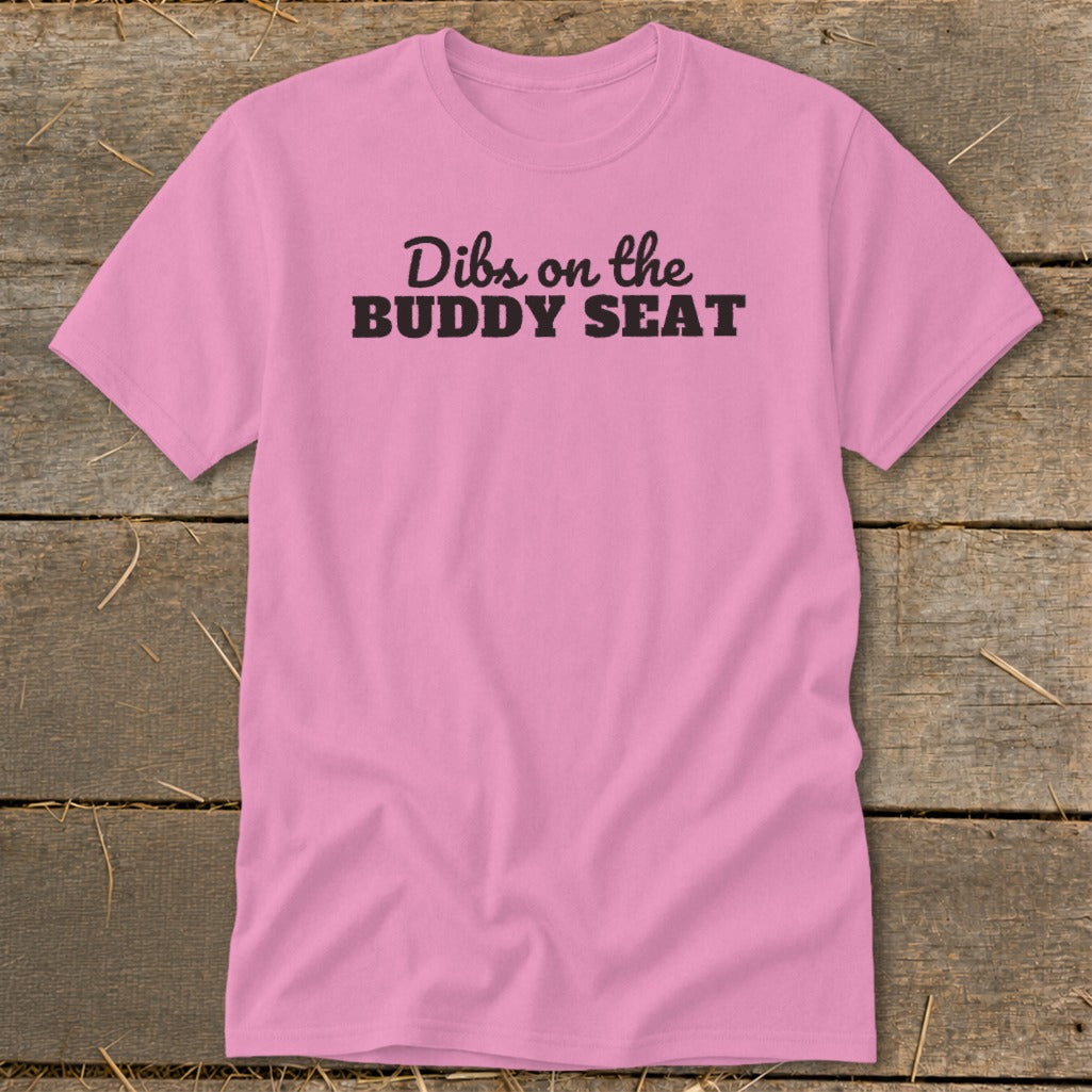 Pink t-shirt with black text "Dibs on the BUDDY SEAT".