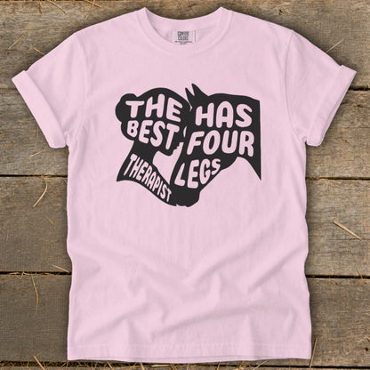 Light pink t-shirt with black graphic text: "The Best Therapist Has Four Legs".