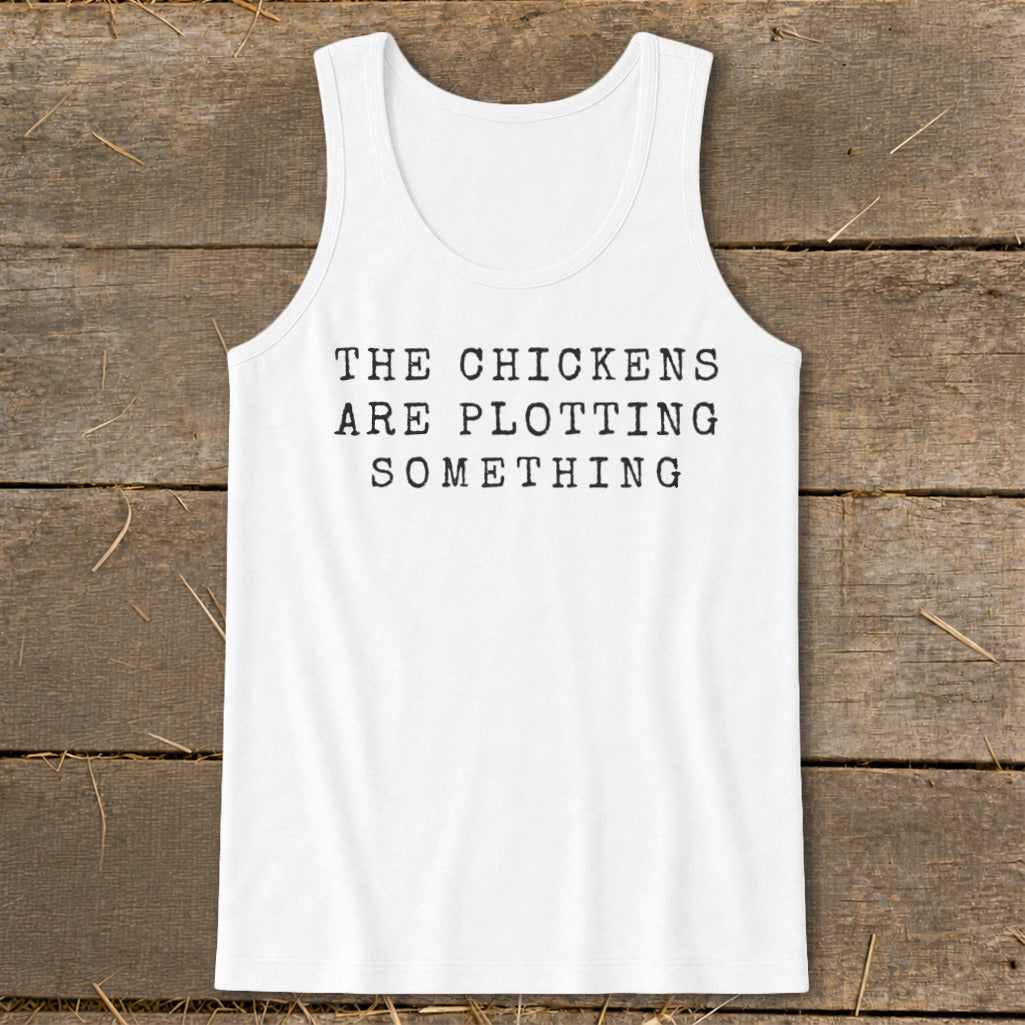 White tank top with black text reading "THE CHICKENS ARE PLOTTING SOMETHING".