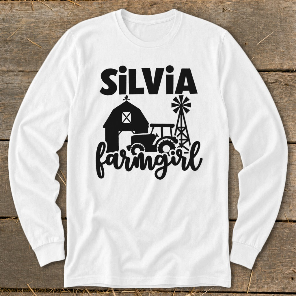 White long sleeve shirt with black "SILVIA farmingirl" text and farm graphics.