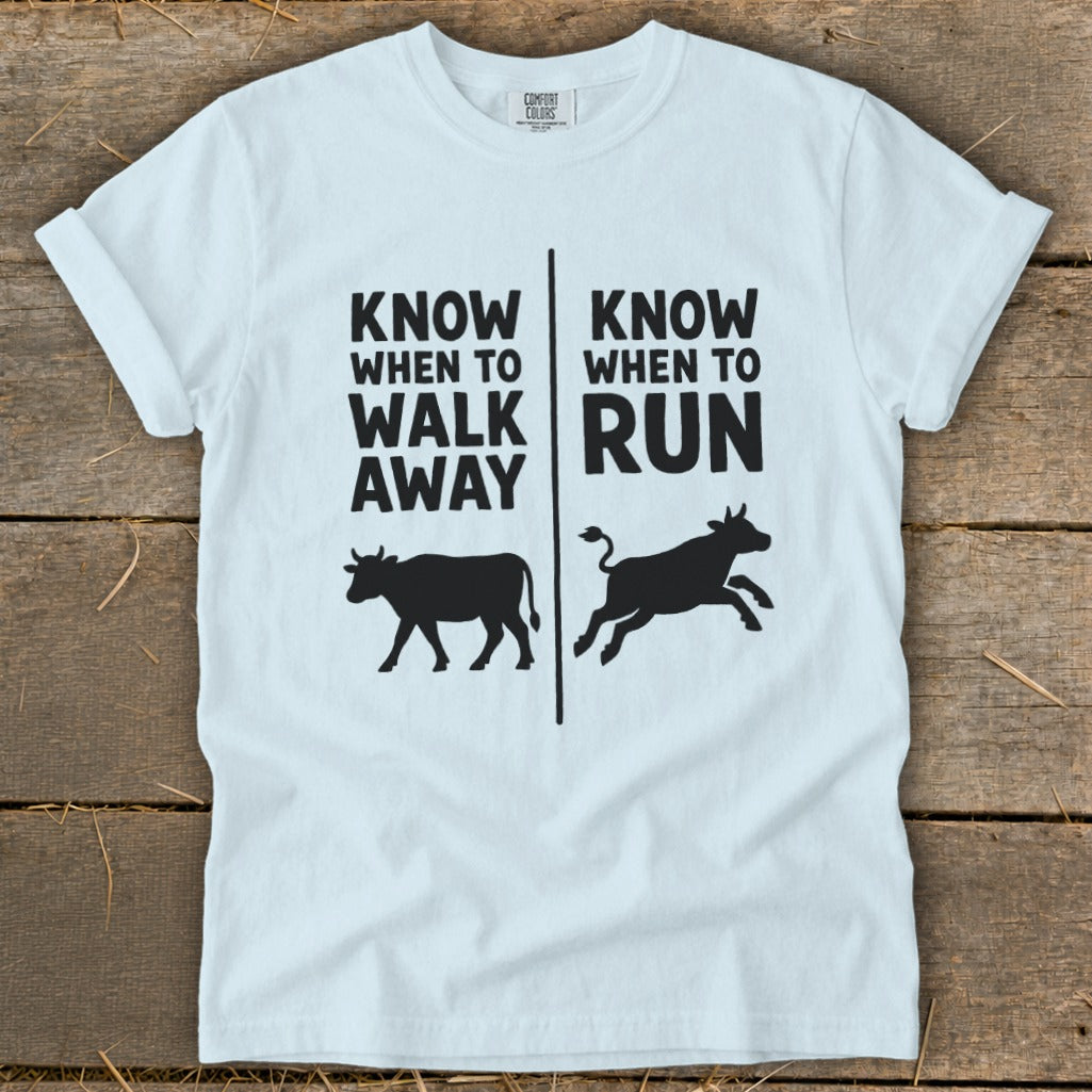 White t-shirt with "Know When To Walk Away" and "Know When To Run" text and cows.
