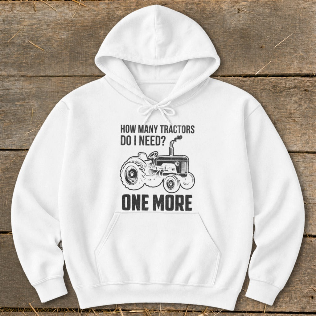 White hoodie with black text and tractor graphic: "How Many Tractors Do I Need? One More."