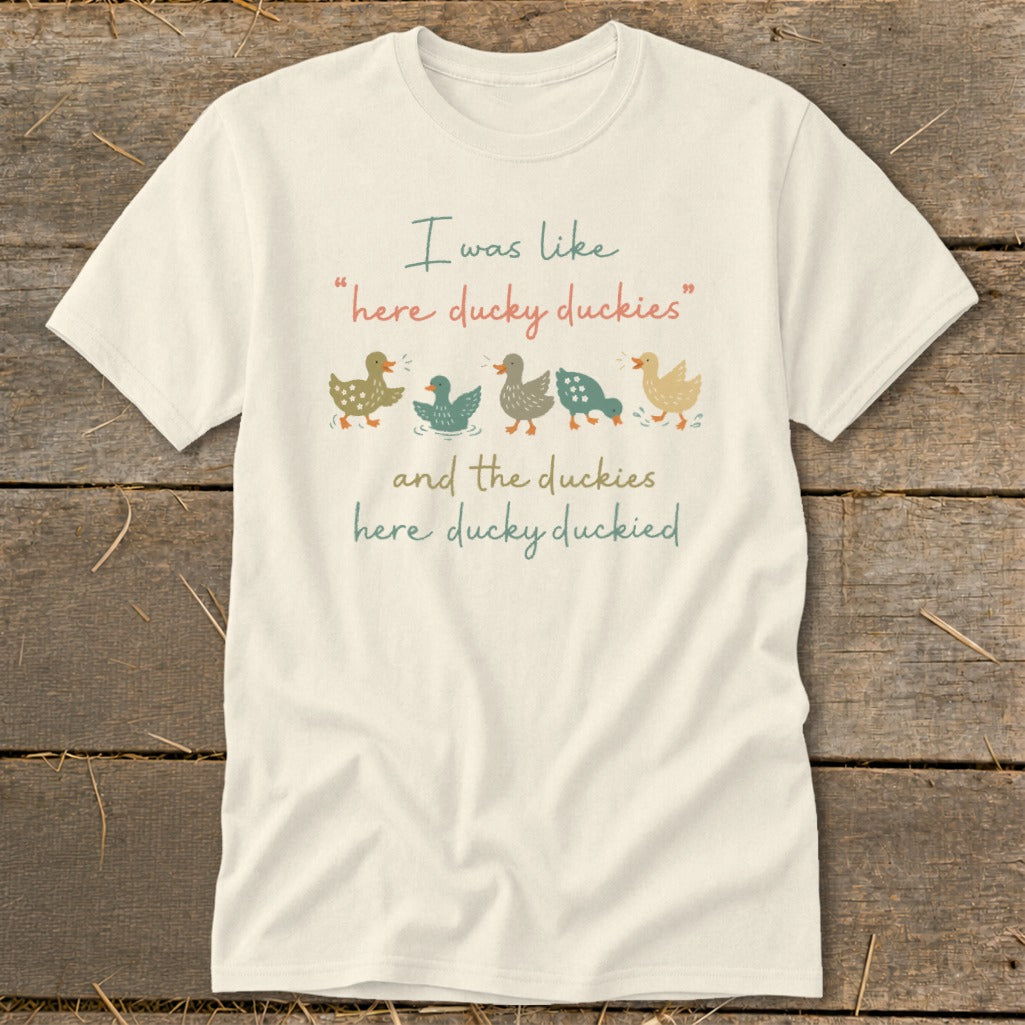 Cream t-shirt with cartoon ducks and text "I was like 'here ducky duckies' and the duckies here ducky duckied".