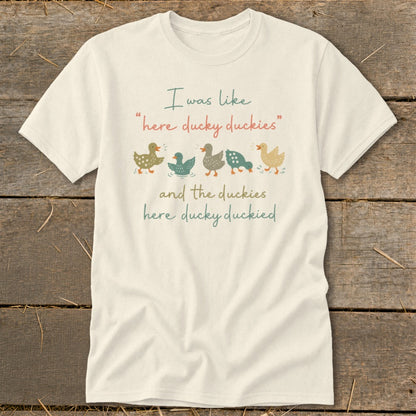 Cream t-shirt with cartoon ducks and text "I was like 'here ducky duckies' and the duckies here ducky duckied".