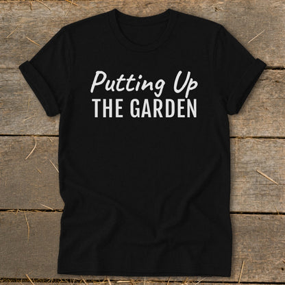 Black t-shirt with white text reading "Putting Up THE GARDEN".