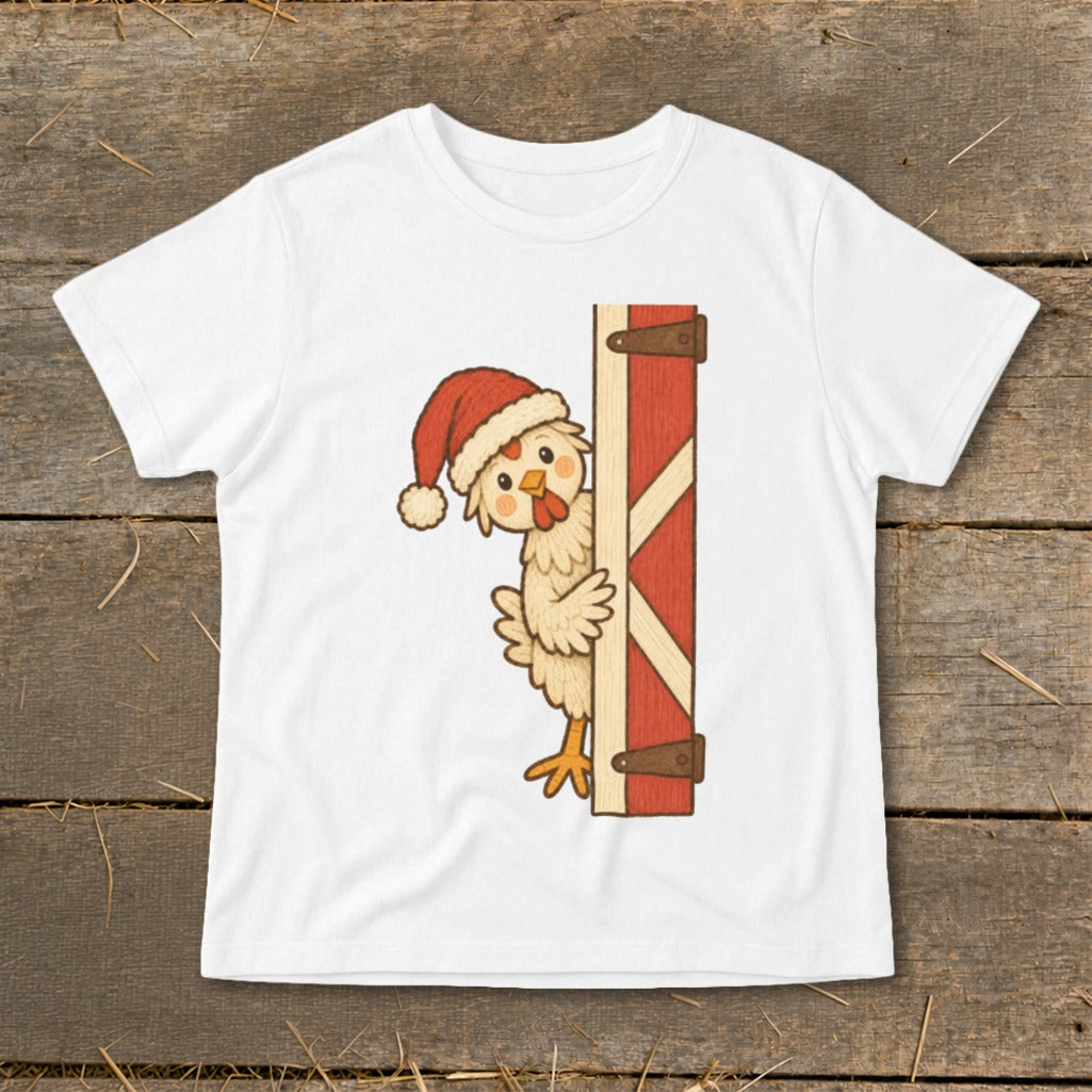 White t-shirt with a cartoon chicken wearing a Santa hat peeking from behind a barn door.