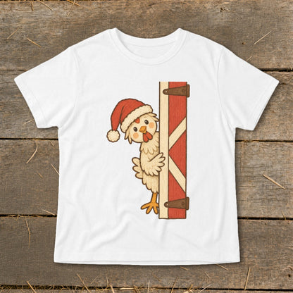 White t-shirt with a cartoon chicken wearing a Santa hat peeking from behind a barn door.