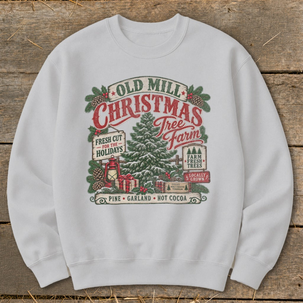 White sweatshirt featuring "Old Mill Christmas Tree Farm" design with festive elements.