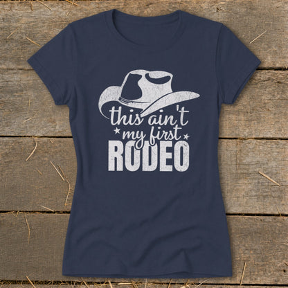 Navy t-shirt with white distressed graphic of a cowboy hat and text "this ain't my first RODEO".