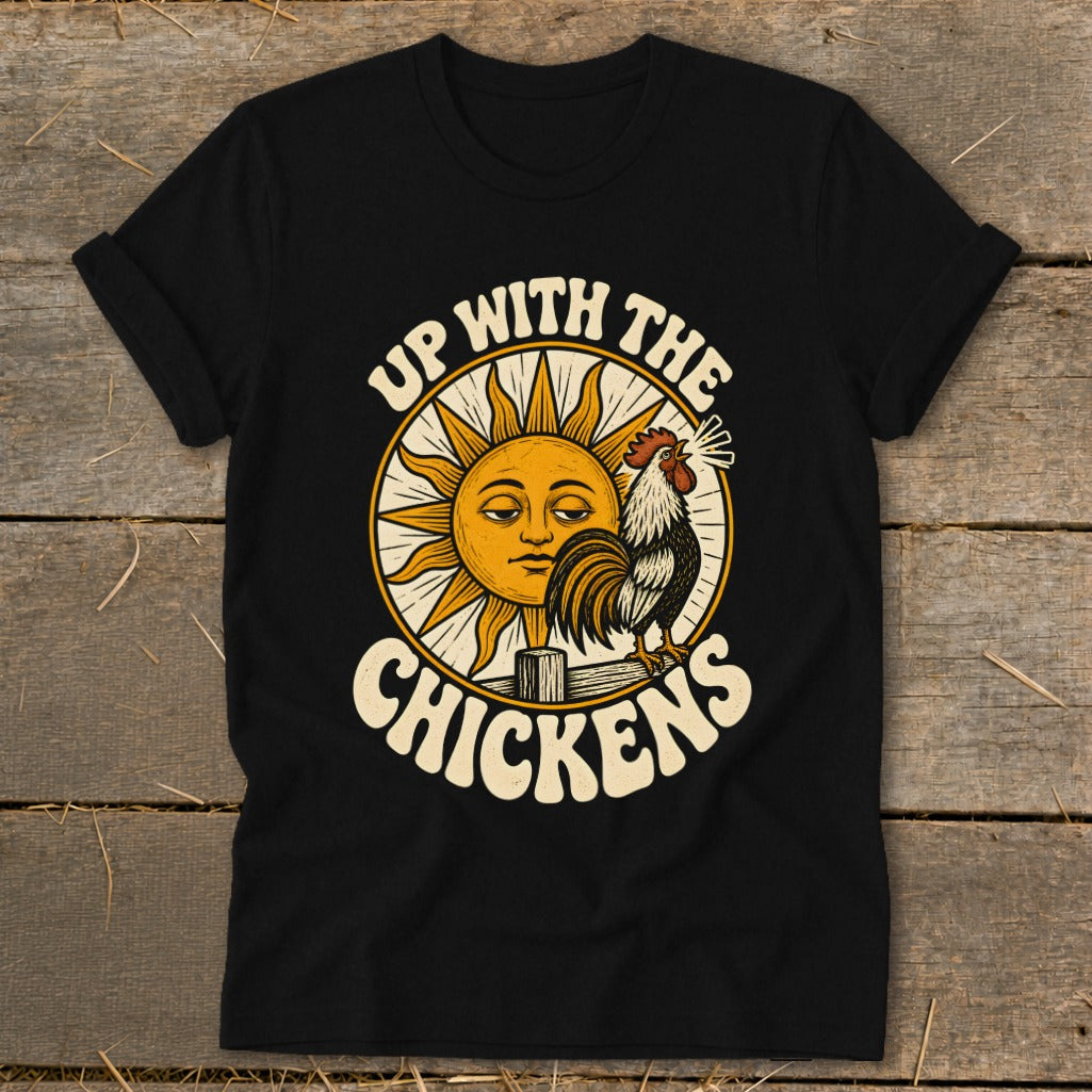 A black t-shirt features a vintage-style graphic of a rooster and sun with the text UP WITH THE CHICKENS.