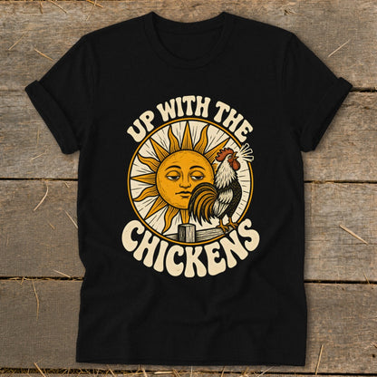 A black t-shirt features a vintage-style graphic of a rooster and sun with the text UP WITH THE CHICKENS.