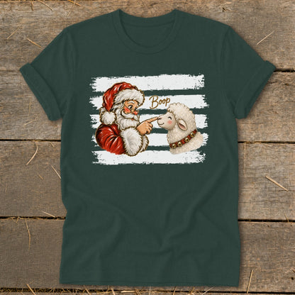 Santa playfully booping a sheep with the word "Boop" on a dark green t-shirt.