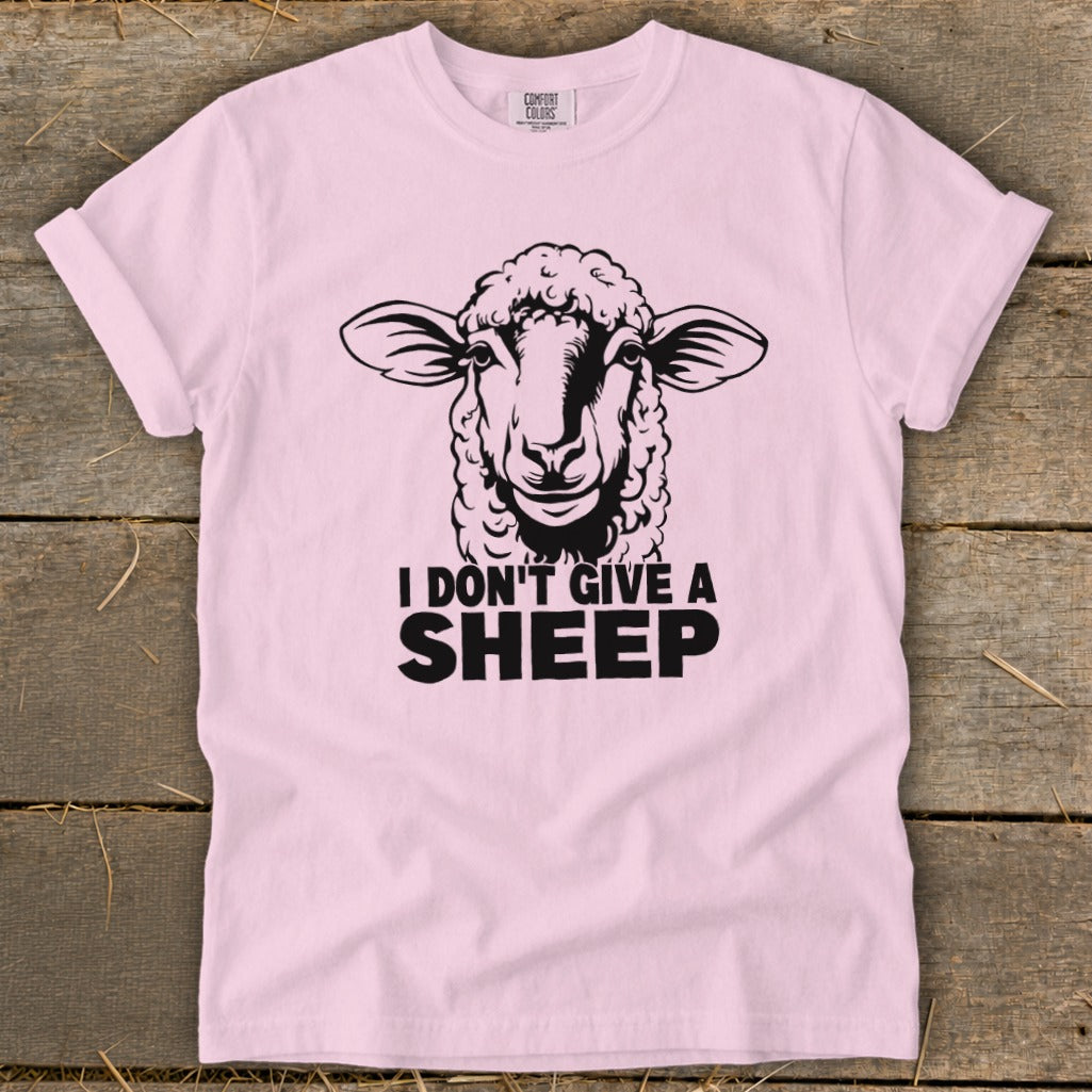 Pink t-shirt with black graphic of a sheep and text "I DON'T GIVE A SHEEP".