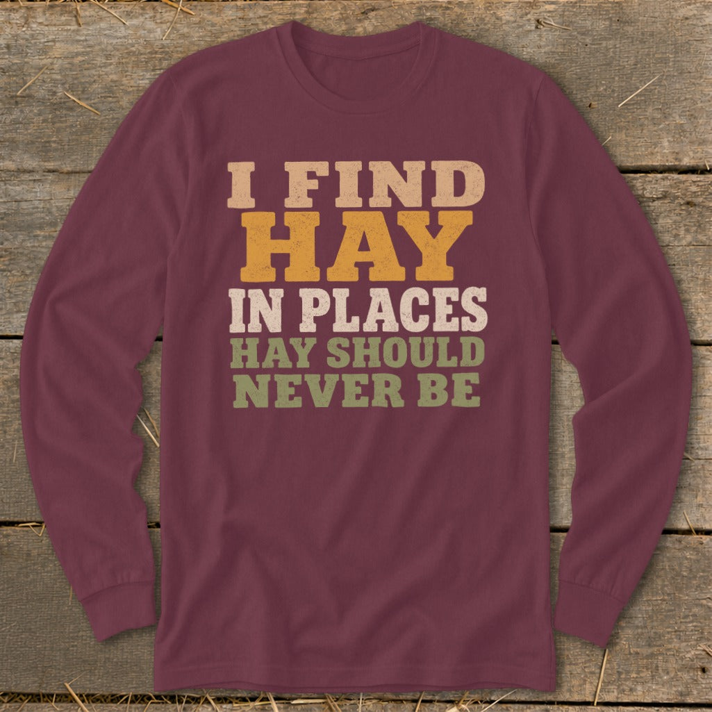 Maroon long-sleeve shirt with text "I FIND HAY IN PLACES HAY SHOULD NEVER BE".
