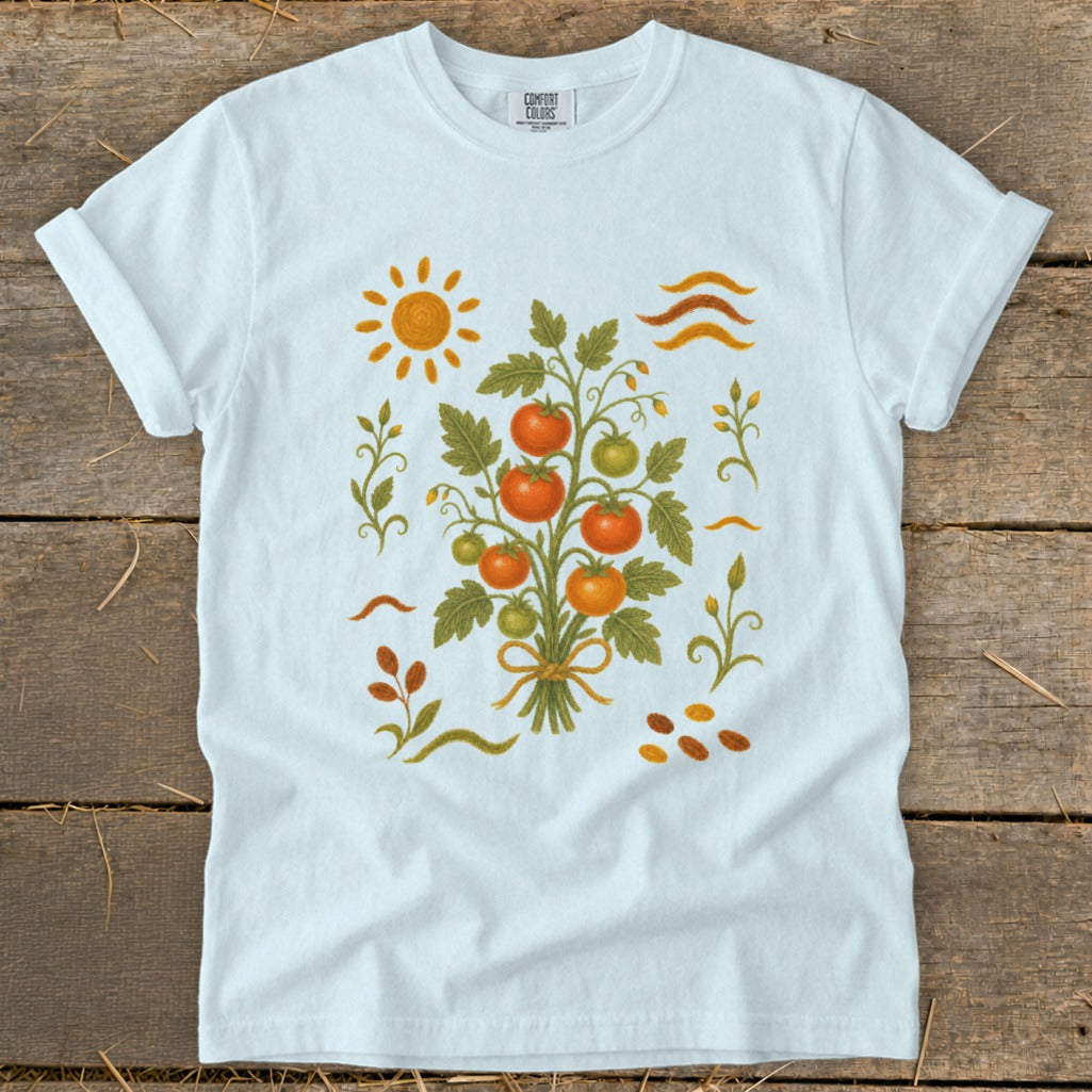White t-shirt with a graphic of a tomato plant, sun, and decorative elements.