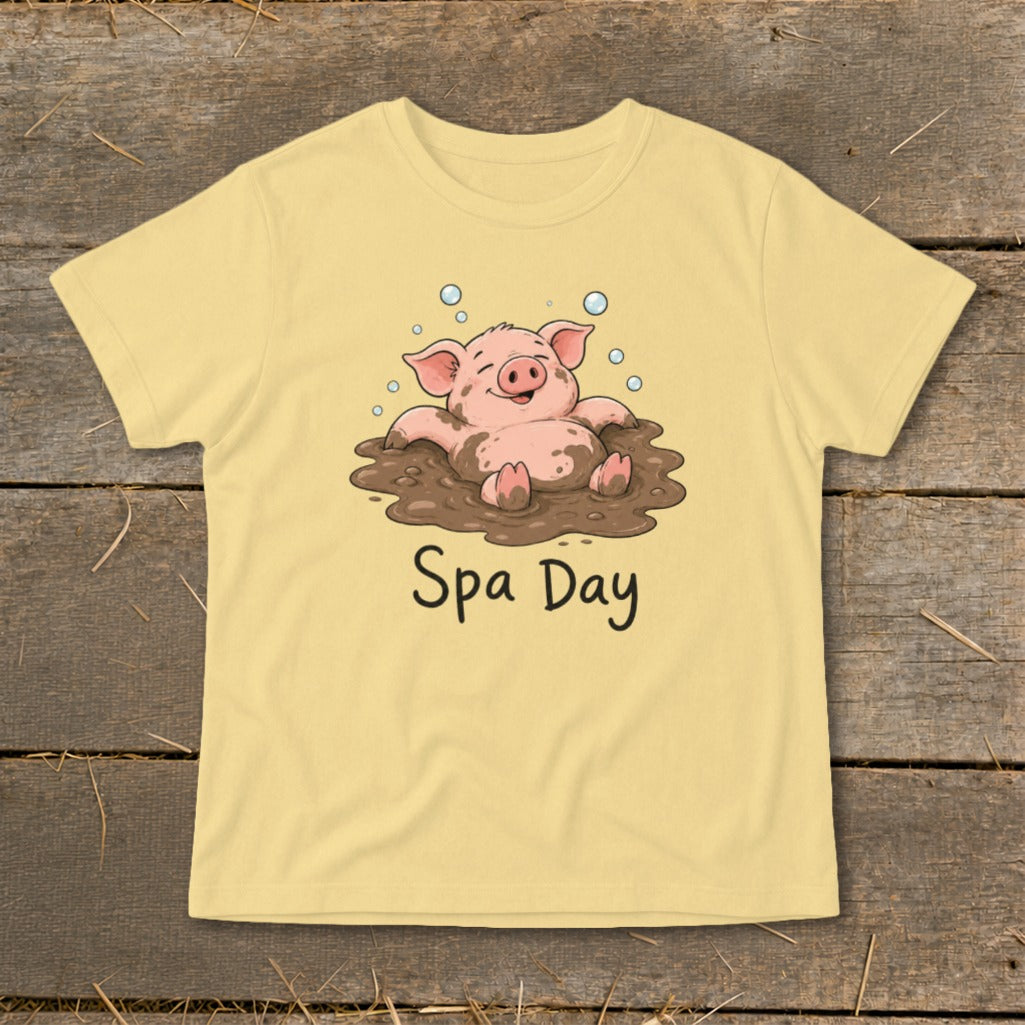 Yellow t-shirt with cartoon pig in mud bath, text reads "Spa Day".