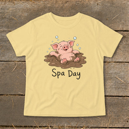 Yellow t-shirt with cartoon pig in mud bath, text reads "Spa Day".