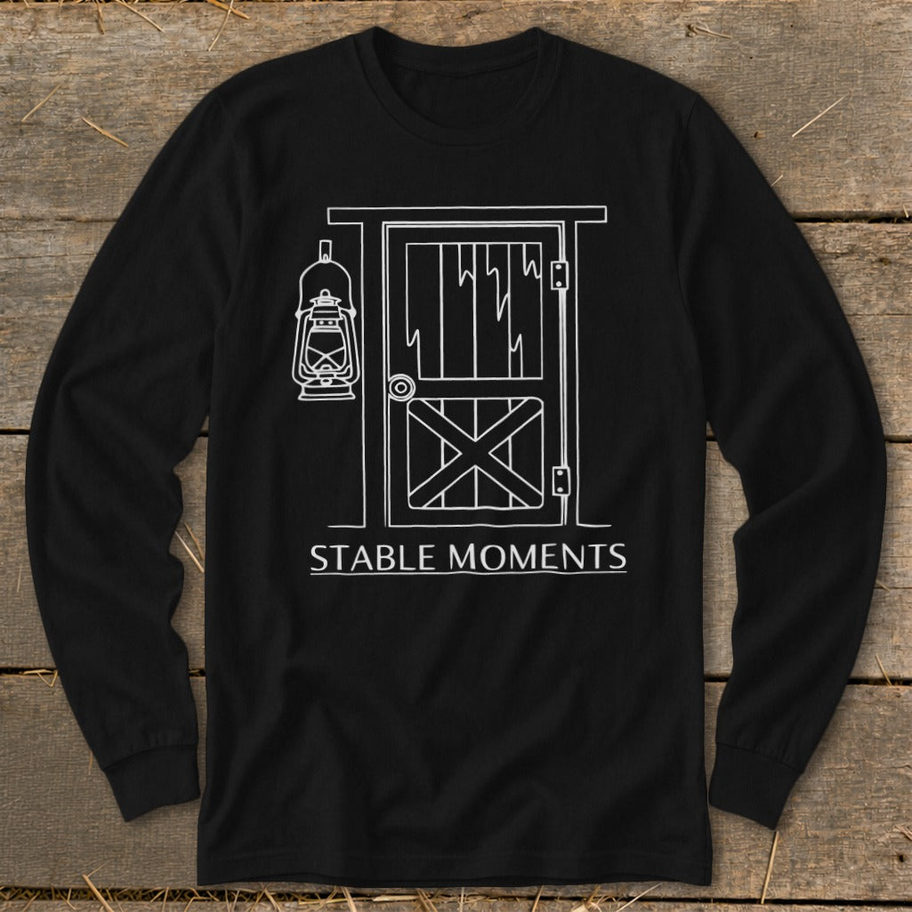 Black long-sleeve shirt with white line art of a barn door and lantern, reading "STABLE MOMENTS."